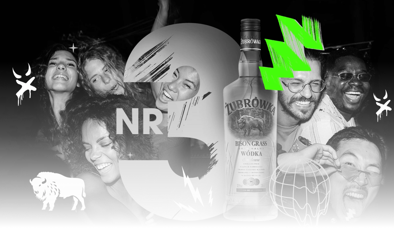 Friends celebrating around a bottle of Żubrówka Bison Grass